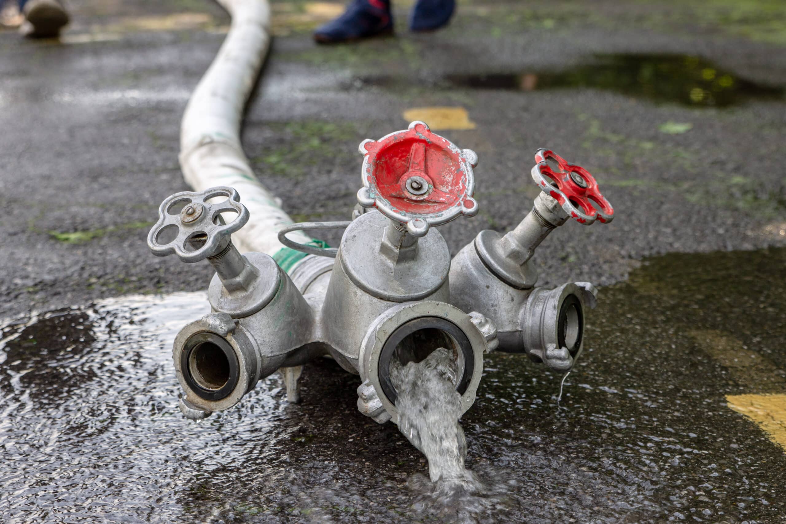 a-fire-hose-with-a-mixer-from-which-water-flows-2024-12-05-22-04-16-utc